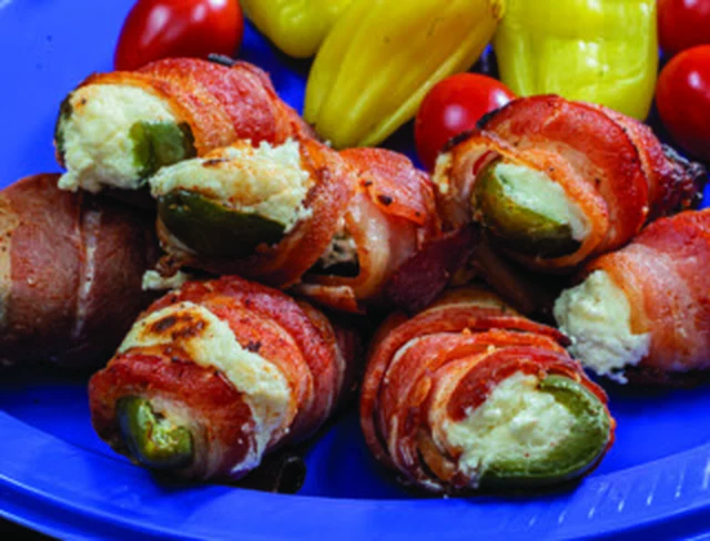 Bacon-wrapped cream cheese jalapeño poppers on a plate